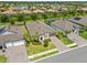 Aerial view of a well-maintained single-Gathering home with a lush green lawn and a brick paved driveway in a gated community at 926 Fernleaf Run, Bradenton, FL 34212