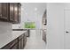 Bright kitchen with dark cabinets, stainless steel appliances, and views of the backyard at 926 Fernleaf Run, Bradenton, FL 34212