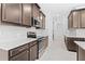 Modern kitchen with stainless steel appliances, white countertops, and ample cabinet space at 926 Fernleaf Run, Bradenton, FL 34212