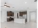 Open-concept kitchen with stainless appliances and island, flowing into the living area at 926 Fernleaf Run, Bradenton, FL 34212