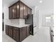 This kitchen offers stainless steel appliances and dark brown cabinets with white countertops at 926 Fernleaf Run, Bradenton, FL 34212