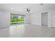 Bright living room with tile floors, a ceiling fan, and views of the backyard at 926 Fernleaf Run, Bradenton, FL 34212