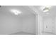 Bright living room with recessed lighting and tile flooring, leading to the front door and other rooms at 926 Fernleaf Run, Bradenton, FL 34212
