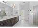 Main bathroom with dual sinks, granite countertops, and a glass enclosed shower, blending style with functionality at 926 Fernleaf Run, Bradenton, FL 34212