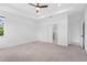 Bright main bedroom with tray ceilings, carpet flooring, and a door to the main bathroom at 926 Fernleaf Run, Bradenton, FL 34212