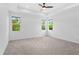 Large main bedroom featuring tray ceilings, recessed lights, plush carpeting and lots of natural light at 926 Fernleaf Run, Bradenton, FL 34212