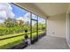 Inviting screened-in patio offers serene views of the fenced backyard and lush landscaping at 926 Fernleaf Run, Bradenton, FL 34212