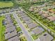 An aerial image of a street view of the community with lake in the background at 926 Fernleaf Run, Bradenton, FL 34212