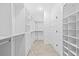 Walk-in closet with carpeted floor and white shelving and drawers at 926 Fernleaf Run, Bradenton, FL 34212