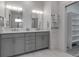 Bright bathroom features double sinks, white counters, and a walk-in closet at 105 Shore Rd, Nokomis, FL 34275