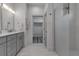 Bright bathroom features double sinks, glass shower, and walk-in closet at 105 Shore Rd, Nokomis, FL 34275