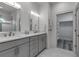 Bright bathroom features double sinks, white counters, and a walk-in closet at 105 Shore Rd, Nokomis, FL 34275