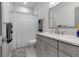 Modern bathroom featuring a gray vanity and shower with white curtain at 105 Shore Rd, Nokomis, FL 34275