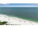 Expansive beach view with white sand, clear water and beachgoers enjoying a sunny day at 105 Shore Rd, Nokomis, FL 34275