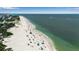Scenic aerial beach view showcasing clear water, white sands, and people enjoying the beachfront at 105 Shore Rd, Nokomis, FL 34275