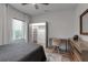 Bright bedroom featuring wood floors, a gray bedspread, desk, and closet at 105 Shore Rd, Nokomis, FL 34275