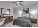 Charming bedroom with gray bedspread, stylish wood dresser, and ceiling fan at 105 Shore Rd, Nokomis, FL 34275