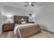 Well-lit bedroom boasts a tufted headboard, side tables, and plush carpet at 105 Shore Rd, Nokomis, FL 34275