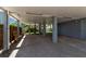 Under-house parking featuring sturdy support pillars, gravel ground cover, and stairway access to the main living area at 105 Shore Rd, Nokomis, FL 34275