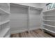 Walk-in closet boasts wood floors, shelving, and closet rods at 105 Shore Rd, Nokomis, FL 34275