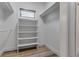 Walk-in closet features wood floors, shelving, and a window at 105 Shore Rd, Nokomis, FL 34275