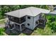 Elevated home featuring a screened in porch and stairs leading to an outside entrance at 105 Shore Rd, Nokomis, FL 34275