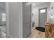 Foyer featuring a gray front door, bench seating, coat hooks, a stylish table, and light wood flooring at 105 Shore Rd, Nokomis, FL 34275