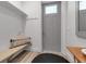 Foyer featuring a gray front door, bench seating and built in storage space at 105 Shore Rd, Nokomis, FL 34275