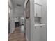 Hallway leading to dining area and features a laundry room with stacked washer at 105 Shore Rd, Nokomis, FL 34275