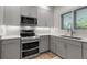 Cozy kitchen featuring stainless steel appliances, including a double oven, and ample counter space for cooking at 105 Shore Rd, Nokomis, FL 34275
