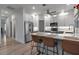 Kitchen with seating at the island, stainless steel appliances, and granite countertops at 105 Shore Rd, Nokomis, FL 34275