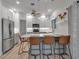Contemporary kitchen features a breakfast bar island, gray cabinets, and stainless appliances at 105 Shore Rd, Nokomis, FL 34275