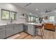 Open-concept kitchen featuring quartz countertops, stainless appliances, and a view into the living room at 105 Shore Rd, Nokomis, FL 34275