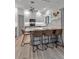 The kitchen features a large island with seating, gray cabinets and stainless appliances at 105 Shore Rd, Nokomis, FL 34275