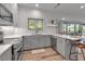 Bright kitchen features quartz countertops, stainless appliances, and seamlessly connects to the home's living spaces at 105 Shore Rd, Nokomis, FL 34275