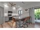 Bright kitchen boasts quartz counters, stainless appliances, and island seating with an adjacent deck entrance at 105 Shore Rd, Nokomis, FL 34275