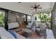 Inviting screened lanai with cozy seating, ceiling fan, and seamless indoor-outdoor living at 105 Shore Rd, Nokomis, FL 34275