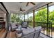 Screened lanai featuring comfortable seating, ceiling fans, and views of the surrounding landscape at 105 Shore Rd, Nokomis, FL 34275