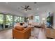 The open concept living room features sliders to a covered porch with wooded views at 105 Shore Rd, Nokomis, FL 34275