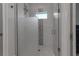Shower with glass door features decorative tile and a window at 105 Shore Rd, Nokomis, FL 34275