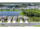 A serene aerial view of a lakeside community with well-maintained homes and green spaces at 10611 Ladybug Cv, Parrish, FL 34219