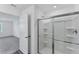 Bathroom featuring bright white shower with glass doors and view into bedroom at 10611 Ladybug Cv, Parrish, FL 34219