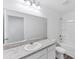 Bathroom with large mirror, speckled granite vanity, and shower-tub combo at 10611 Ladybug Cv, Parrish, FL 34219