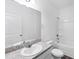 Bright bathroom features a large mirror, single sink vanity, and shower over tub at 10611 Ladybug Cv, Parrish, FL 34219