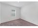Bedroom with a window for natural light and cozy carpet at 10611 Ladybug Cv, Parrish, FL 34219