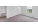 Bedroom with neutral carpet, white walls, and view from single window and doorway at 10611 Ladybug Cv, Parrish, FL 34219