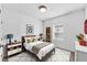 Bright bedroom with bed, white walls, area rug, and furniture at 10611 Ladybug Cv, Parrish, FL 34219
