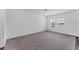 Spacious, carpeted bedroom with a view of the lake from the dual windows allowing natural light at 10611 Ladybug Cv, Parrish, FL 34219