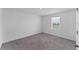 Bright bedroom with neutral carpet, white walls, and view from single window at 10611 Ladybug Cv, Parrish, FL 34219