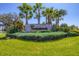 Summerwoods community entrance sign surrounded by lush landscaping and palm trees at 10611 Ladybug Cv, Parrish, FL 34219